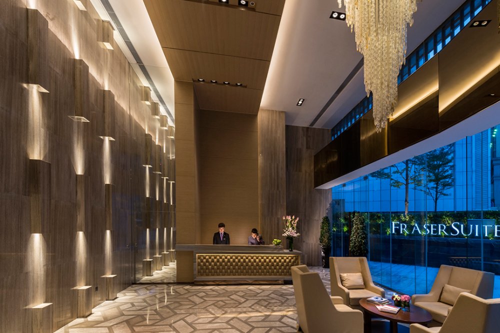 Luxury hotel lobby with Fraser Suites signage 